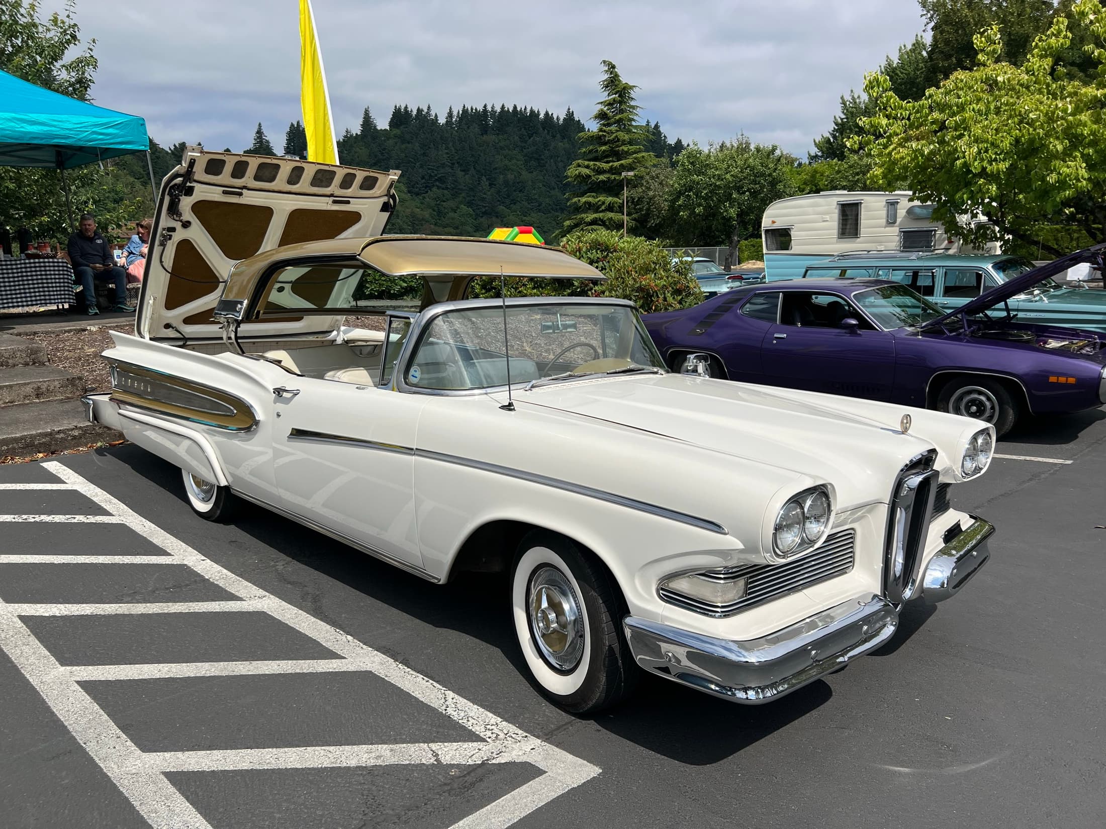 White classic car parked in the lot.